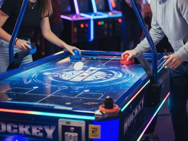 Air hockey is popular with young people and familie